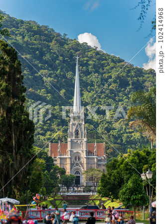 Petropolis Cathedral with lush jungle mountain in the background 102414968