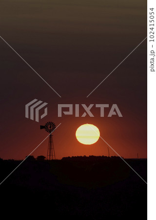 Windmill in countryside at sunset, Pampas, Patagonia,Argentina. Windmill in countryside at sunset, Pampas, Patagonia,Argentina. 102415054