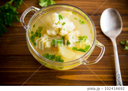 cooked chicken soup with cauliflower and vegetables in a bowl 102416692