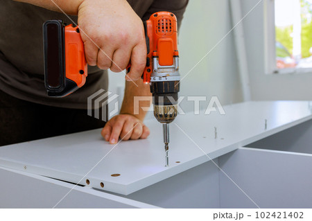 An process of assembling furniture closet cabinets that needed to be installed by carpenter 102421402