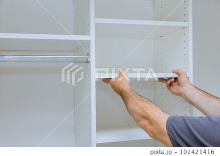 Handyman service in process of assembly and installation for furniture closet cabinet 102421416