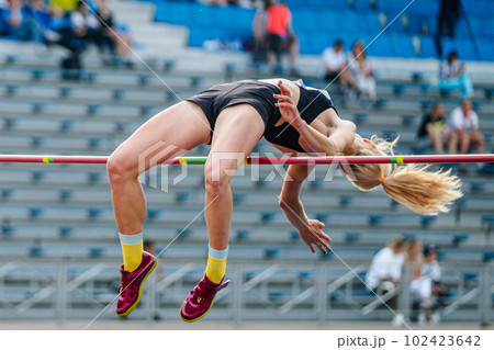 close-up girl jumper high jump in summer athletics championships 102423642