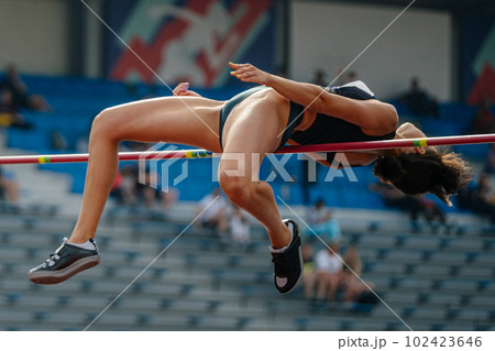 close-up woman athlete high jump in summer athletics championships, fosbury flop technique close-up woman athlete high jump in summer athletics championships, fosbury flop technique 102423646