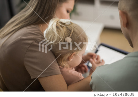 Deaf kid with hearing aid cochlear implant have fun with parents - Hear aid and medicine innovating technology and diversity concept 102428639