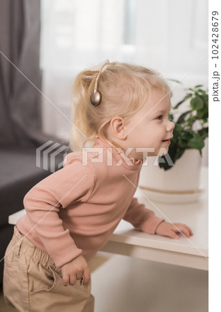 Funny baby with cochlear implant. Hear aid and medicine innovating technology and diversity concept 102428679