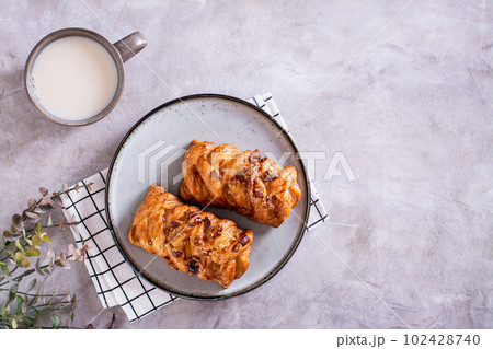 Wicker buns with cinnamon, nuts and maple syrup and a cup of coffee for Swedish fika time top view 102428740