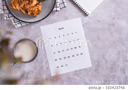Calendar sheet for planning during a snack with latte and buns in fika time top view 102428748