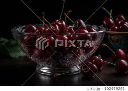 Ripe appetizing cherries in a large transparent glass bowl on the table made with generative AI 102429261