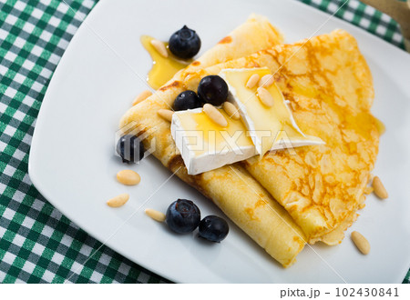 Crepes with brie and honey 102430841