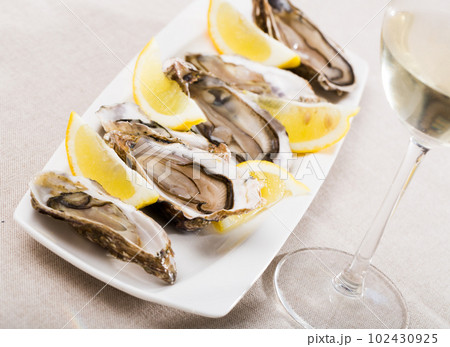 Oysters with lemon on plate Oysters with lemon on plate 102430925
