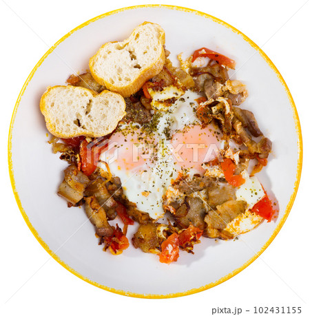 Top view of fried eggs with bacon and tomatoes Top view of fried eggs with bacon and tomatoes 102431155