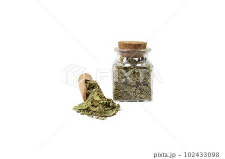 Dried leaves o Lemon verbena in latin Aloysia citrodora in wooden scoop and glass jar on isolated on white background. Medicinal herb. Dried leaves o Lemon verbena in latin Aloysia citrodora in wooden scoop and glass jar on isolated on white background. Medicinal herb. 102433098