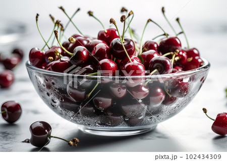 Ripe appetizing cherries in a large transparent glass bowl on a white table made with generative AI 102434309
