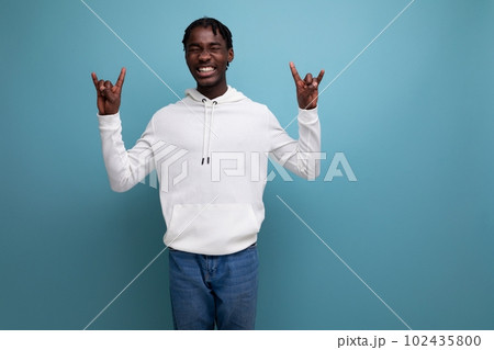handsome optimistic man with dreadlocks on a blue background 102435800