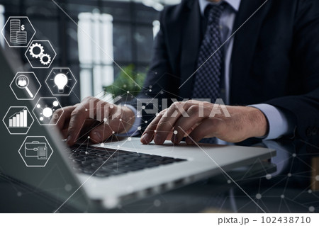 Man hands typing on laptop computer keyboard and surfing the internet on office table 102438710