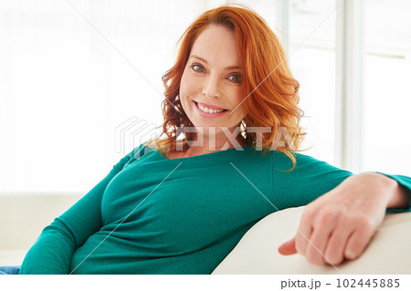 Happy at home. Cropped portrait of a mature woman relaxing on the sofa at home. 102445885
