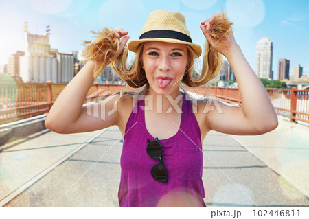Its a good day for some city fun. a smiling young woman walking around the city in the summertime. Its a good day for some city fun. a smiling young woman walking around the city in the summertime. 102446811