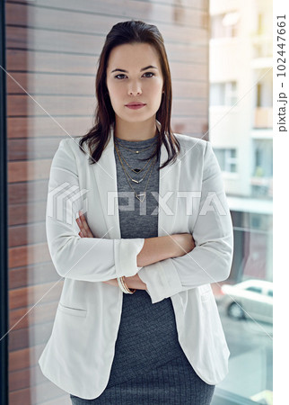 Shes got razor sharp focus. Portrait of a successful businesswoman standing in their office. 102447661