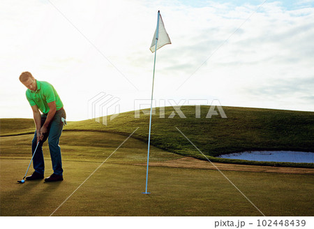 It all comes down to this. a young man spending the day on a golf course. 102448439
