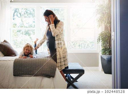 Kids bring the most joy into our lives. a pregnant woman bonding with her little son at home. 102448528