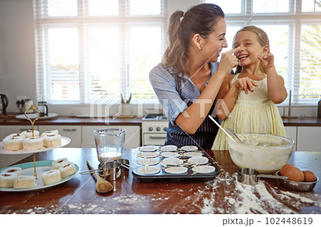 Family fun in the kitchen. a mother and her daughter baking in the kitchen. 102448619