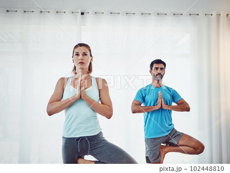 Find peace within yourself. a couple practising yoga at home. 102448810