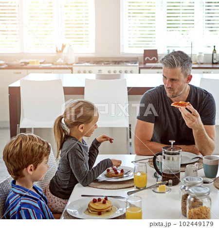 Hes a hands-on dad. a family having breakfast together. Hes a hands-on dad. a family having breakfast together. 102449179