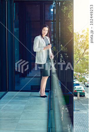 Taking a micro break out on the balcony. a young businesswoman having a coffee break at work. 102449253
