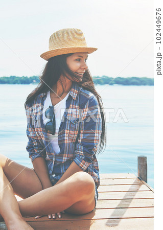 Just taking it all in...an attractive young woman enjoying a day on the beach. Just taking it all in...an attractive young woman enjoying a day on the beach. 102449676