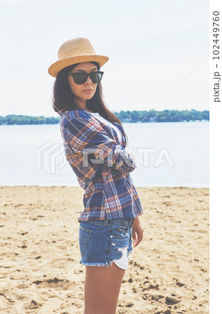 The beach is my home away from home. an attractive young woman enjoying a day on the beach. The beach is my home away from home. an attractive young woman enjoying a day on the beach. 102449760