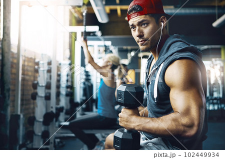 Successful people do daily what others do occasionally. a man doing weight training at the gym. 102449934