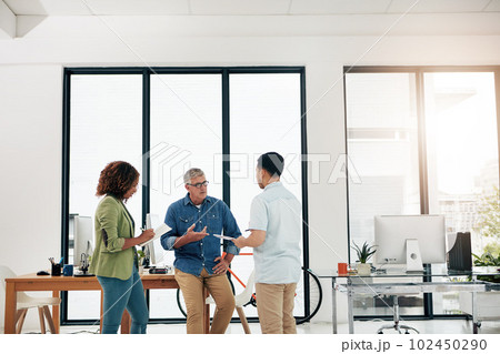 Lets see what youve got...three creative professionals talking in the office. 102450290