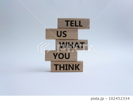 Tell us what you think symbol. Wooden blocks with words Tell us what you think. Beautiful white background. Business and Tell us what you think concept. Copy space. 102452334