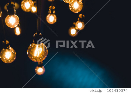 vintage, retro, old fashioned yellow and orange light bulbs hanging on wires vintage, retro, old fashioned yellow and orange light bulbs hanging on wires 102459374