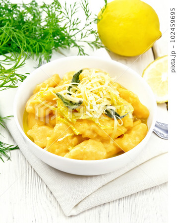 Gnocchi pumpkin in bowl on wooden board Gnocchi pumpkin in bowl on wooden board 102459695