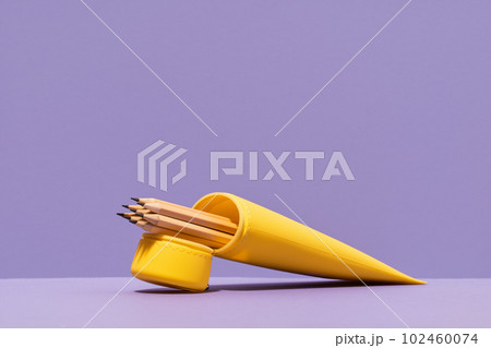 Yellow pencil case with pencils on lilac violet background. stationery with copy space for back to school or education and craft concept. Bright Yellow minimal. Neon acid colors Yellow pencil case with pencils on lilac violet background. stationery with copy space for back to school or education and craft concept. Bright Yellow minimal. Neon acid colors 102460074