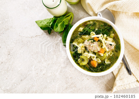Soup with meatballs and pasta in bowl on granite top Soup with meatballs and pasta in bowl on granite top 102460185