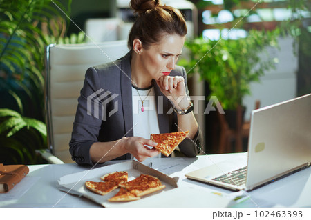 concerned modern accountant woman in modern green office 102463393