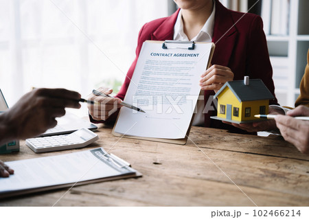 Considering buying a home, investing in real estate. Broker signs a sales agreement. agent, lease agreement, successful deal 102466214