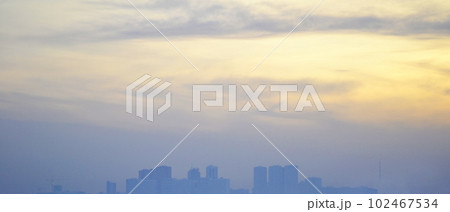 city at dusk, city buildings against the sky, polluted air, poor ecology 102467534