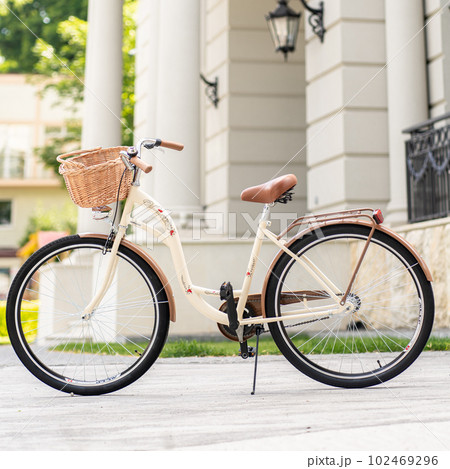 View of urban city bicycle parked on street in neighborhood. Sun bike summer. No people. 102469296