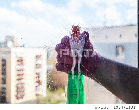 spraying of washing liquid on surface of window 102471131