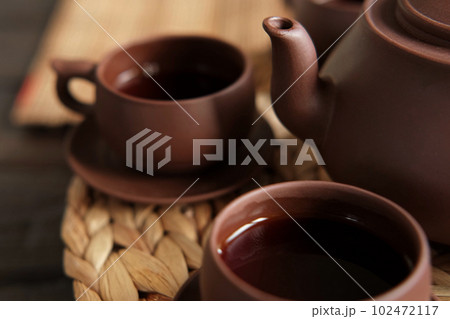 Tea Ceremony. Traditional Asian Tea Utensil, Serving Authentic Set. Person Pouring Tea from Brown Pottery Teapot to Teacup. Bamboo Tray. Lifestyle. Wellness Balance Health. Tea Brewing Equipment 102472117