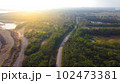 Aerial view green and brown forest and asphalt road in autumn, Top view forest road trip travel. 102473381