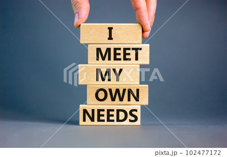 I meet my own needs symbol. Concept words I meet my own needs on wooden blocks. Businessman hand. Beautiful grey table grey background. Business and i meet my own needs concept. Copy space. 102477172