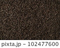 Background of black fanning or broken loose leaf tea. Close up, top view. 102477600