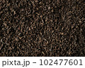 Background of black fanning or broken loose leaf tea. Close up, top view. 102477601