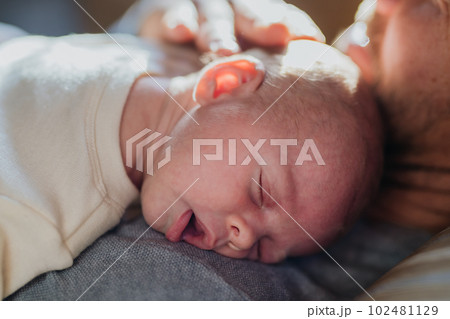 Close-up of father cudddling his little son. 102481129