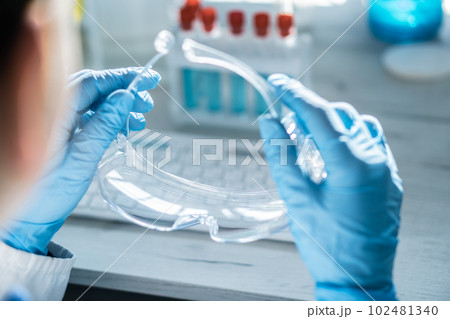 A chemist analyzes the results of an experiment with samples of various drugs on a computer in a medical laboratory. 102481340