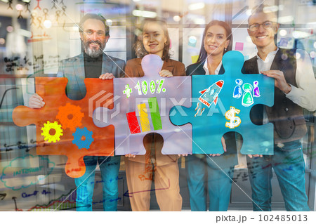 Teamwork of partners connect puzzle pieces as integration and startup 102485013
